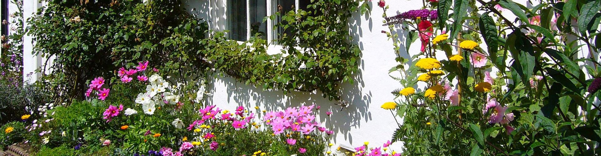 Wood in cottage gardens, British garden wood elements, Traditional garden wooden structures, Rustic wood in UK gardens